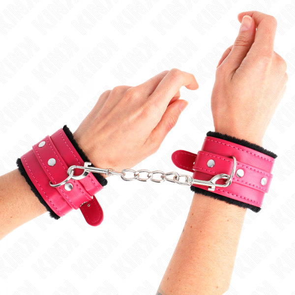 img_189366_291566d658238a2e79bd425e097d67bf_1.png KINK - MUÑEQUERAS FORRADAS PREMIUM NEGRO CON CORREA FUCSIA AJUSTABLE 17-29 CM X 6 CM