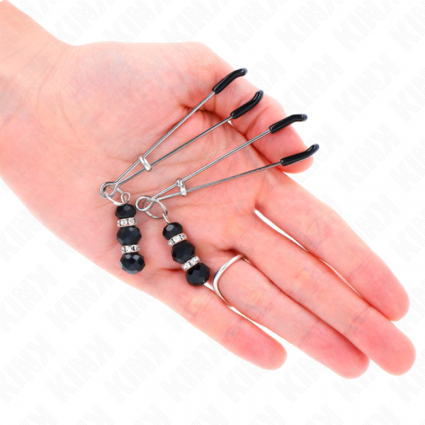 img_190248_4eb51d68c1a581ea9884845214b465d5_1.png KINK - PINZAS PARA PEZONES PLATEADA FINA CON TRIPLE BOLA DE VIDRIO NEGRO 7 CM
