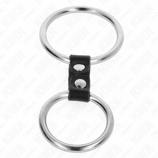 img_193430_561573033b81dd4cb660a42fa2f7b5ac_1.png KINK - ANILLO PENE DOBLE METAL 3.7 CM A 5 CM CONECTADOS POR CORREA POLIPIEL MODELO 2